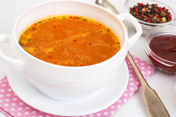 Spicy soup with tomatoes and curry on a white background