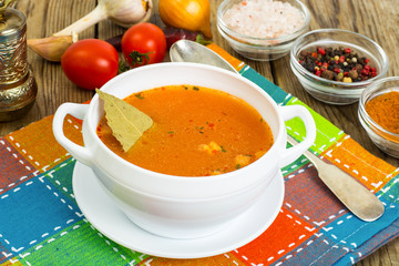 Soup in white bowl on wooden background.