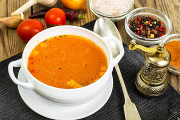 Soup in white bowl on wooden background.