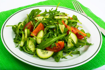 Healthy and diet food: arugula, cucumbers, tomatoes