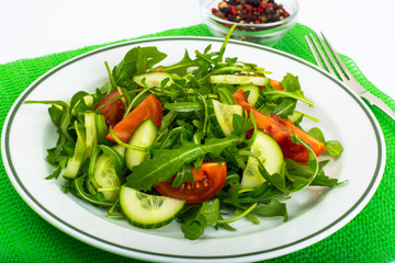 Healthy and diet food: arugula, cucumbers, tomatoes