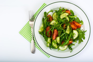 Healthy and diet food: arugula, cucumbers, tomatoes
