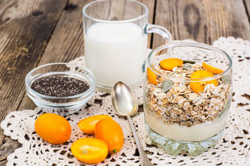 Healthy breakfast, oatmeal with kumquats, granola, yoghurt, chia