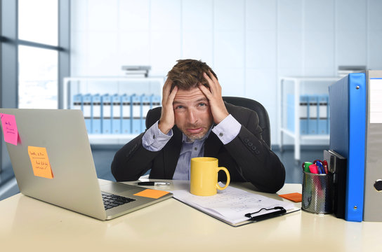  exhausted businessman suffering stress at office computer desk