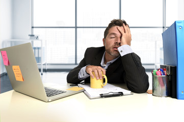  exhausted businessman suffering stress at office computer desk