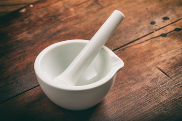 Mortar and pestle on wooden background