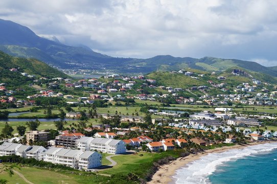 A view over St. Kitts Island with residential area on the foreground and lush green hills on the background