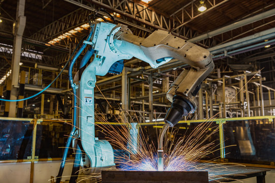 Industrial robot is welding in car factory