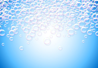 Soap bubbles abstract blue background with rainbow colored airy foam
