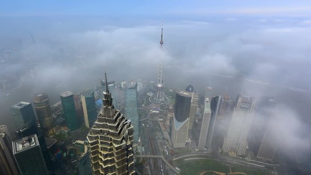 Aerial view of high-rise buildings with Huangpu River in Shanghai, China.Over the sea of ​​clouds.