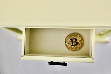 Bitcoin physical coin in the drawer