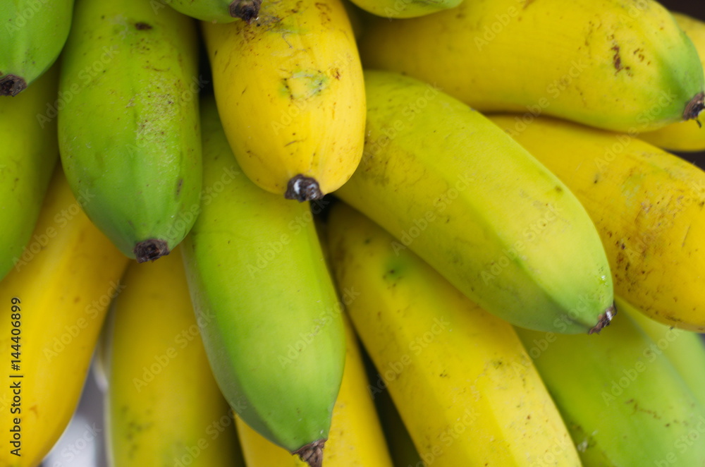 Wall mural banana bunch of growing ripe yellow and green