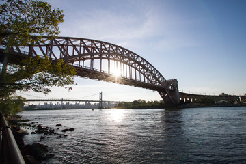 Fototapeta na wymiar The Hell Gate Bridge and the Triborough bridge over the river with blue sky, Astoria park, New York