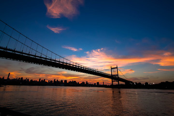 Triborough bridge and Manhattan city in silhouette, New York