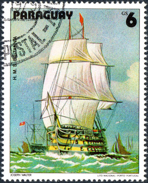 UKRAINE - CIRCA 2017: A postage stamp printed in Paraguai shows Sailing Ship HMS Britannia, from the series Sailboat painting, circa 1979