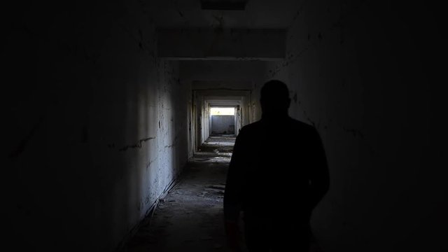 Abandoned creepy hallway, men walk 