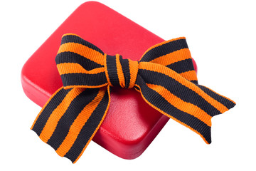 Red case for the award on the ninth of May and a bow on it, on a white background