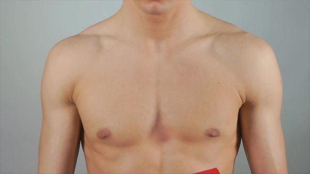 Sexy guy with no shirt holding a present. A great gift. 