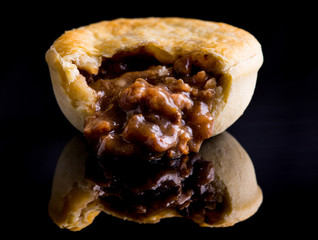 Meat pie on reflective surface