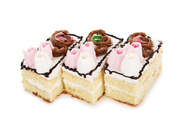 biscuit white cake decorated with cream flowers isolated on white