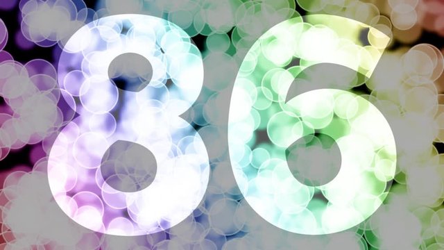 Eighty six to eighty seven years birthday fade in/out animation with color gradient moving bokeh background. Animation: 90 frames still with number, 180 fade out, 30 clear, 180 fade in, 300 still.