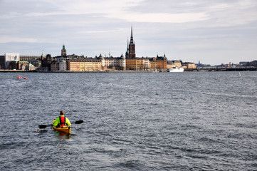  Cityscape of Stockholm with Canoe kayak flowing in the river. - obrazy, fototapety, plakaty
