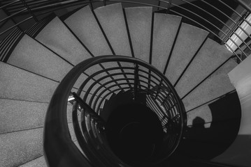 Naklejka premium Black and white image of spiral staircase.