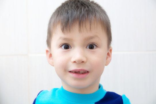 Amazed boy face, surprised child portrait