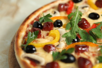 Rustic pizza with with tomatoes, hum,  bacon, sausages,  mushrooms,  mozzarella and parsley. Soft focus