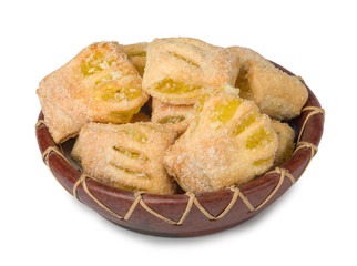 Puff pastry cookies with apple jam in ceramic plate isolated on white background.