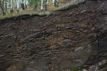 The exposed rock layers in the technogenic canyon.