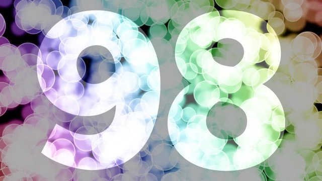 Ninety eight to ninety nine years birthday fade in/out animation with color gradient moving bokeh background. Animation: 90 frames still with number, 180 fade out, 30 clear, 180 fade in, 300 still.