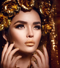 Golden holiday makeup. Golden wreath and necklace. Fashion art hairstyle, manicure and makeup