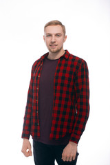 Fototapeta premium Portrait of a blond woman on a white background In a shirt in a cage