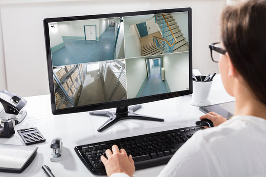 Businesswoman Watching CCTV Footage On Computer