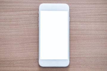 Mockup image of white mobile phone with blank white screen on wooden table background