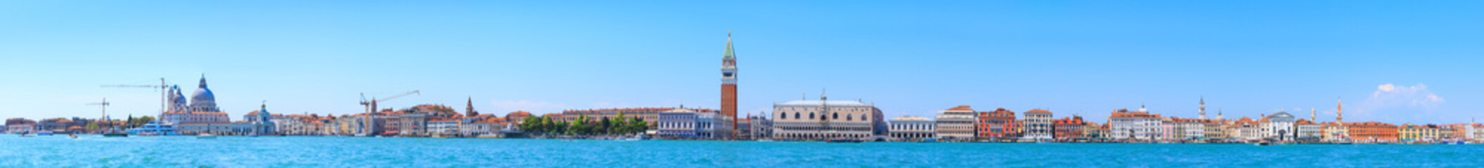 Fototapeta na wymiar Panoramic cityscape beautiful ancient town. Venice, laguna view on Basilica di Santa Maria della Salute, Piazza San Marco with Campanile, Doge Palace, and Arsenale. Venice, Italy.
