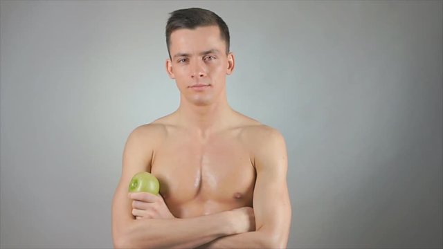 Healthy lifestyle. Sexy guy and green apple.  
