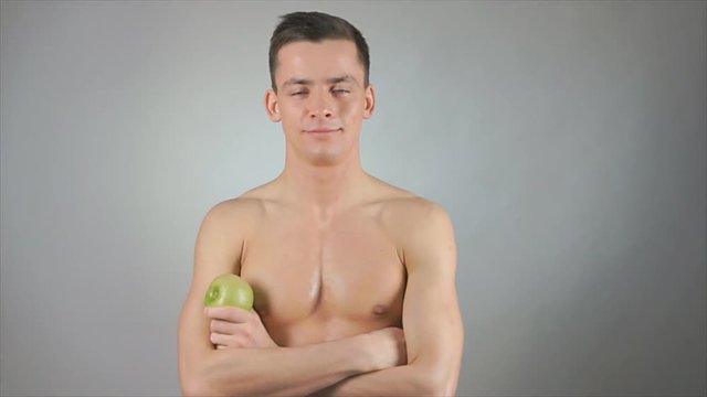 Healthy lifestyle. Sexy guy and green apple.  