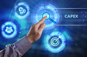 Business, Technology, Internet and network concept. Young businessman working on a virtual screen of the future and sees the inscription: Capex