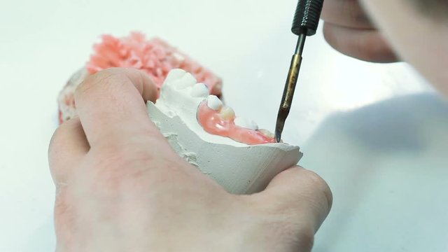 Close up of making human prosthesis with dental wax