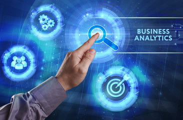 Business, Technology, Internet and network concept. Young businessman working on a virtual screen of the future and sees the inscription: Business analytics