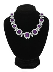 Pendant with purple gem stones on black mannequin isolated on white