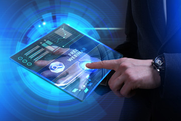 Business, Technology, Internet and network concept. Young businessman working on a virtual screen of the future and sees the inscription: Free webinar