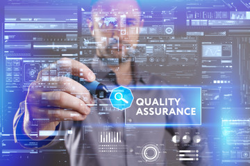 Business, Technology, Internet and network concept. Young businessman working on a virtual screen of the future and sees the inscription: Quality assurance