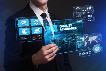 Business, Technology, Internet and network concept. Young businessman working on a virtual screen of the future and sees the inscription: Quality assurance