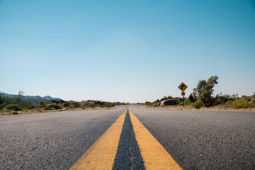Straight road in California Desert A low angle shot of an endless desert road in a California Desert. Road to success.  © veeterzy