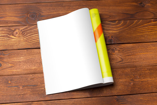 Blank book or magazine cover on wood background