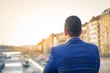 Man looking from a bridge