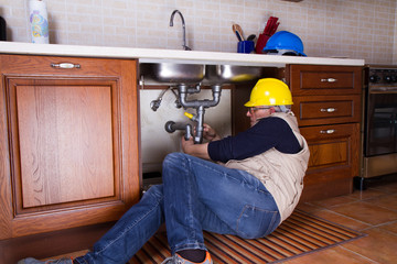 plumber at work to fix a sink